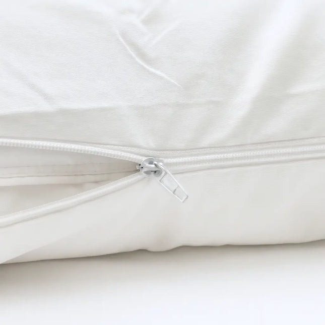 Close-up of a white quilt with a zipper on a white background