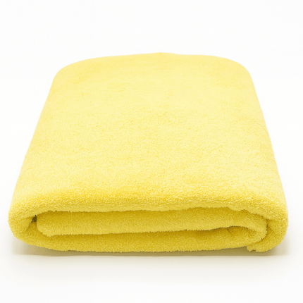 Folded yellow towel on a white background