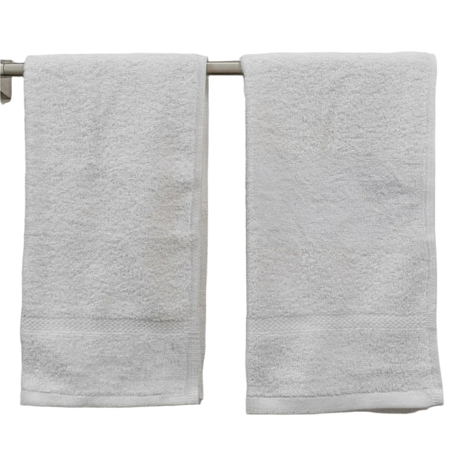 2 pinnacle white hotel hand towels hanging