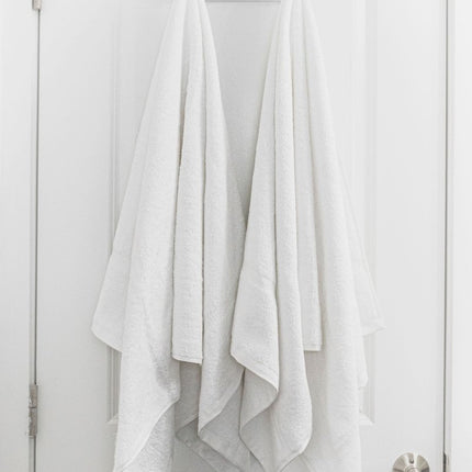 Soft and durable Pinnacle Classic Hotel Bath Towel 27" x 50" hanging elegantly, perfect for hotels and rentals.