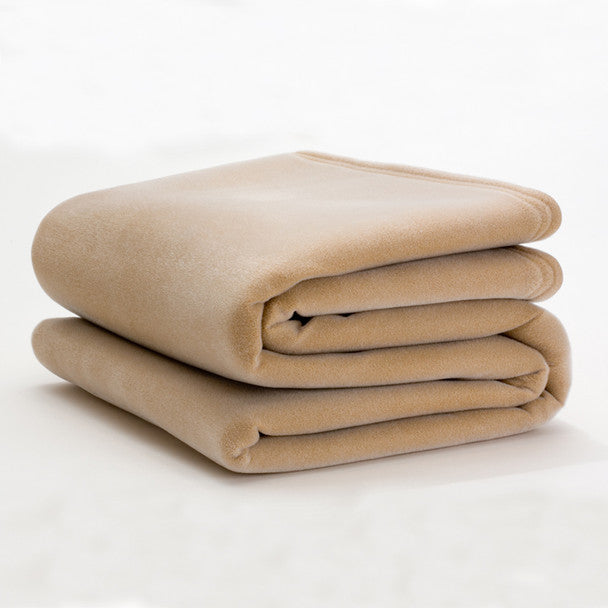 tan colored blanket folded on white background