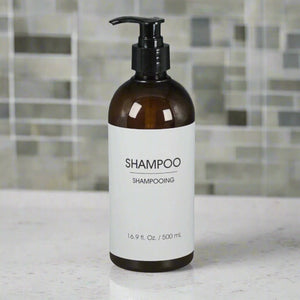 a refillable shampoo dispenser amber bottle in a bathroom