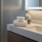white towels folded on white vanity