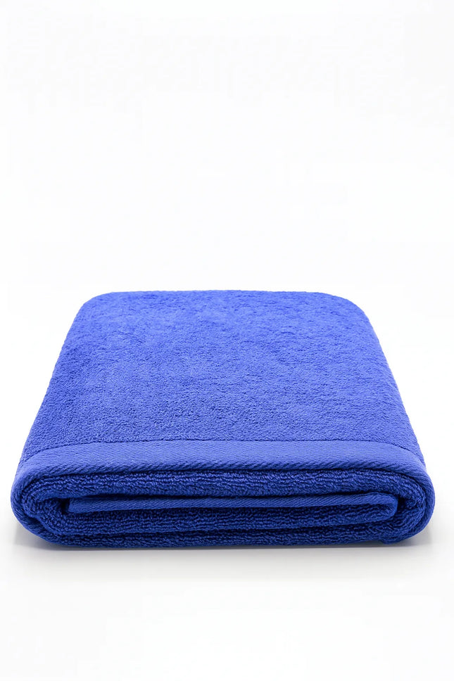 A folded royal blue terry cloth towel on a clean white background.