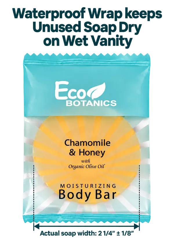 A packaged Eco Botanics Chamomile & Honey moisturizing body bar wrapped in a bright aqua waterproof wrap, with text above and below explaining that the wrap keeps unused soap dry on wet vanity. The soap itself is visible through the clear lower section and appears yellow with a sunburst pattern.