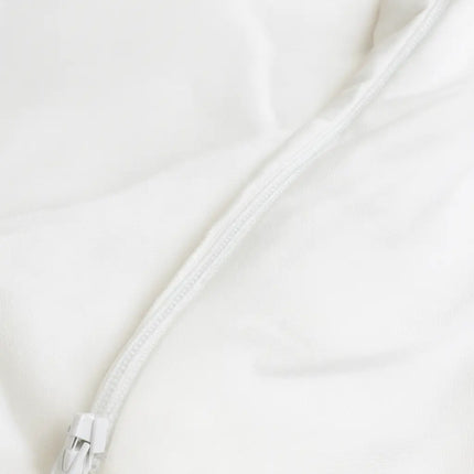 Close-up of a white zipper on a white background