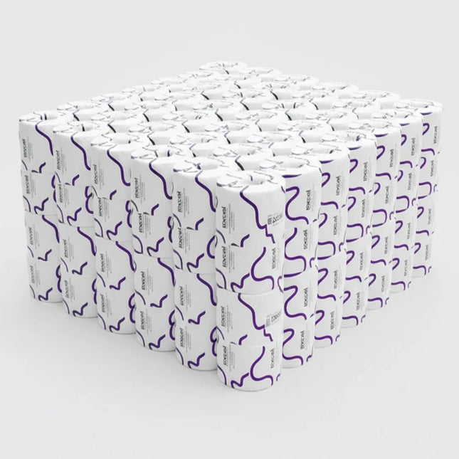 a cube of individually wrapped rolls of toilet paper with purple squiggly line on wrapper