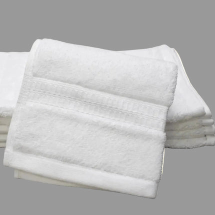 Stack of white folded washcloth towels on a white background