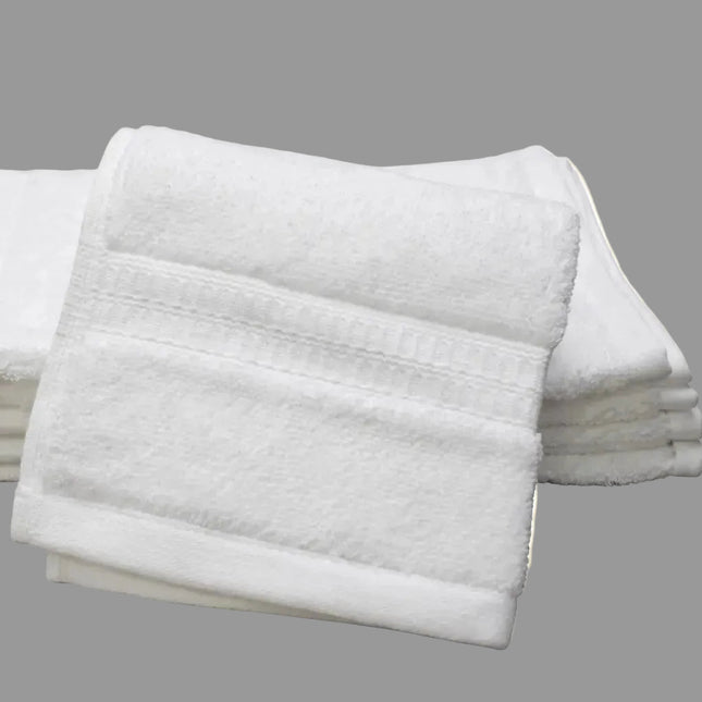 Stack of white folded washcloth towels on a white background