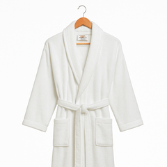 White bathrobe on a wooden hanger against a white background