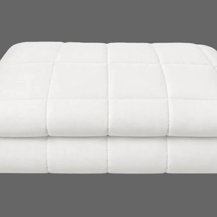 A folded white quilted mattress topper or comforter with a grid pattern, shown on a clean white background.