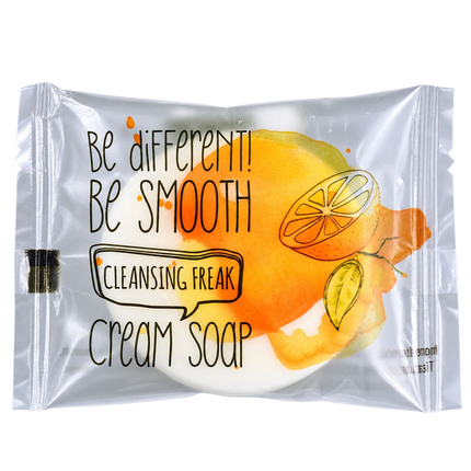 A single packaged cream soap bar on a plain white background. The product is sealed in a clear plastic pouch with printed text reading 'Be different! Be smooth Cleansing Freak Cream Soap' and an orange-and-yellow citrus illustration.