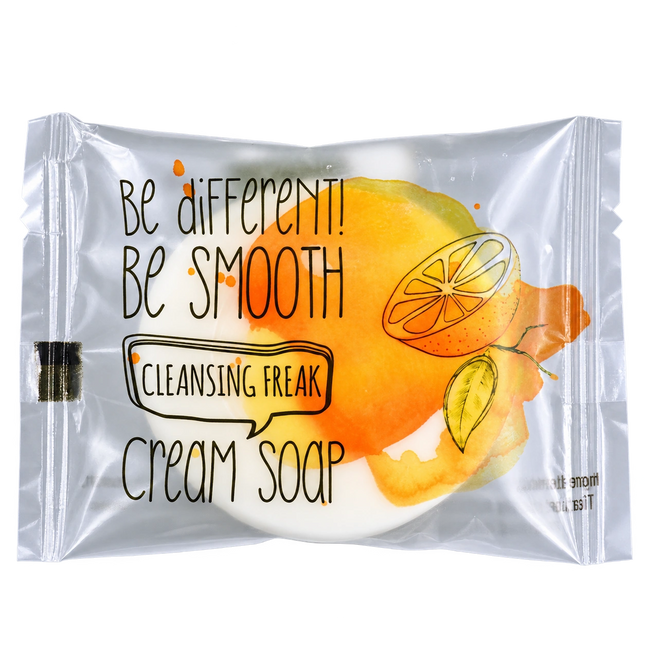 A single packaged cream soap bar on a plain white background. The product is sealed in a clear plastic pouch with printed text reading 'Be different! Be smooth Cleansing Freak Cream Soap' and an orange-and-yellow citrus illustration.