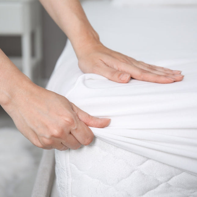 Snugly fitting Martex Ultra Touch Microfiber Fitted Sheets – Full being adjusted on a mattress for comfort and durability.