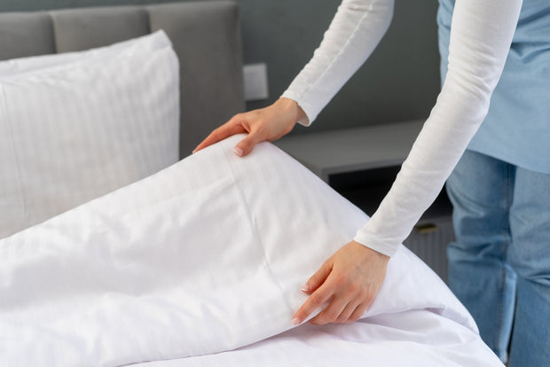 Housekeeping Staff Preparing Hotel Room Bed